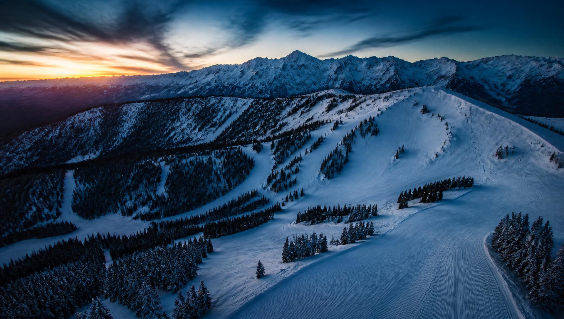 Aerial view of snow-covered runs and back bowls at Vail Mountain at dawn